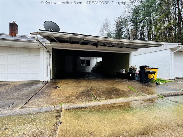 garage featuring concrete driveway