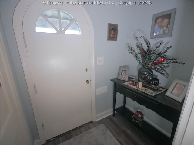 entrance foyer featuring baseboards and wood finished floors