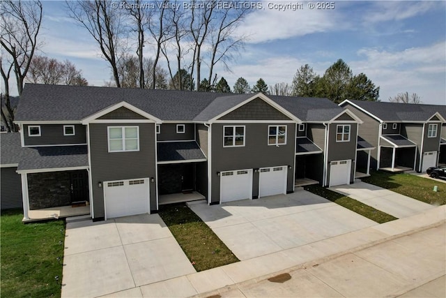 view of front of property with a residential view, a garage, and concrete driveway