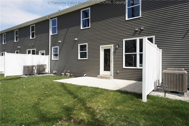 back of property featuring a patio, central AC unit, fence, and a lawn