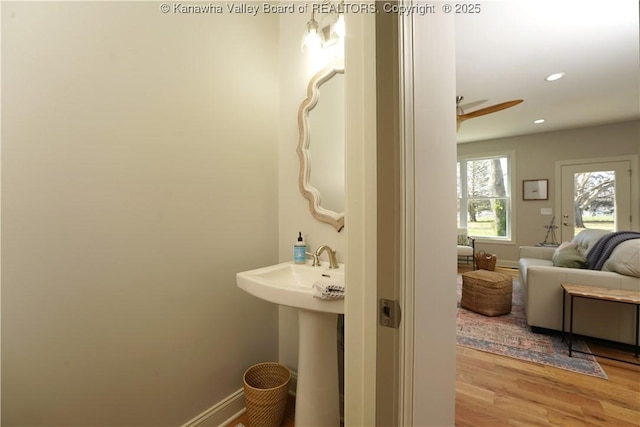 bathroom featuring a sink, baseboards, recessed lighting, and wood finished floors