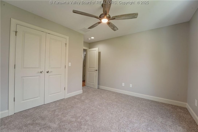 unfurnished bedroom with carpet floors, baseboards, a ceiling fan, and a closet