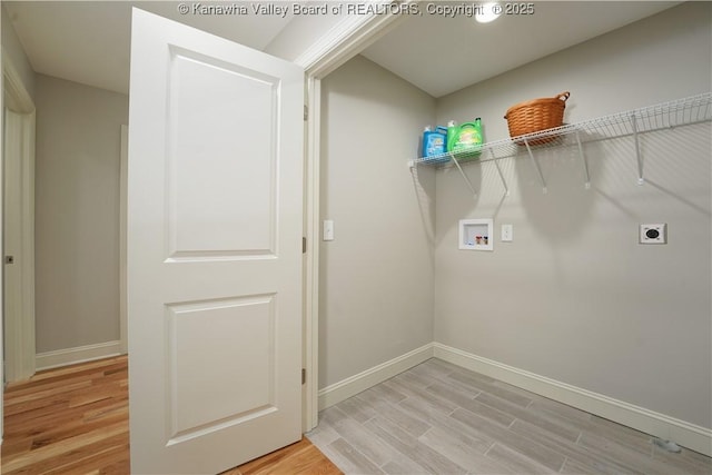 laundry area with hookup for an electric dryer, hookup for a washing machine, laundry area, and light wood finished floors