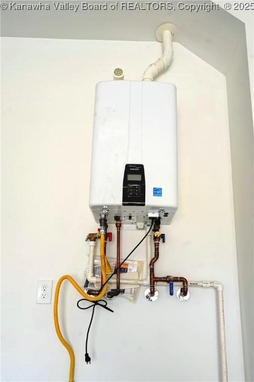 utility room featuring tankless water heater