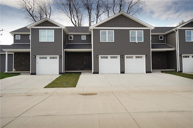 view of front of property with a garage and concrete driveway