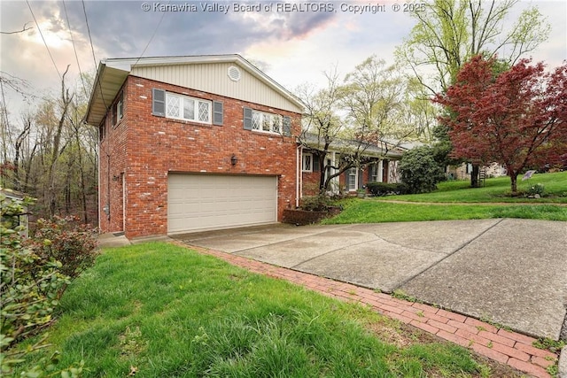 906 Hughes Dr, Saint Albans, WV 25177 - view of home's exterior with an attached garage, a lawn, concrete driveway, and brick siding