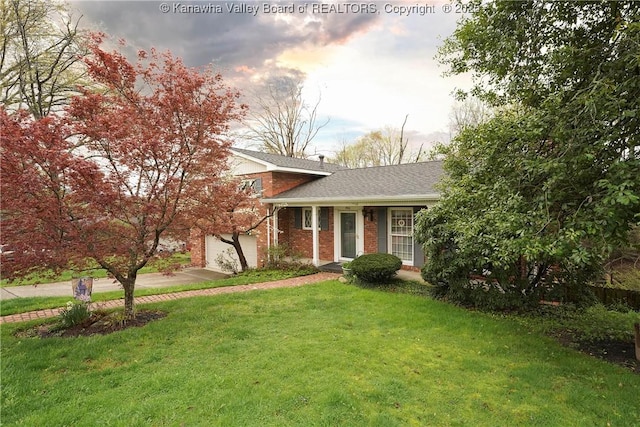 906 Hughes Dr, Saint Albans, WV 25177 - view of front facade featuring a garage, a front yard, brick siding, a shingled roof, and driveway