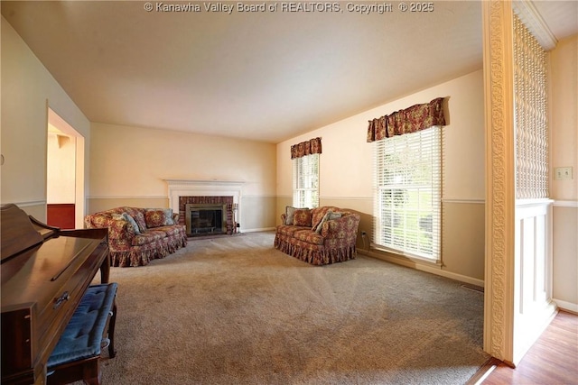 906 Hughes Dr, Saint Albans, WV 25177 - carpeted living room with baseboards and a brick fireplace