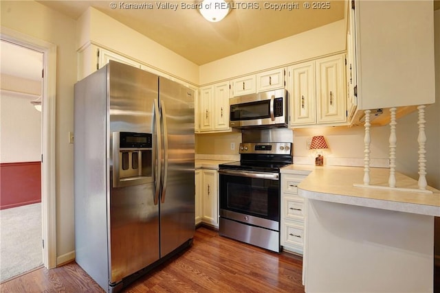 906 Hughes Dr, Saint Albans, WV 25177 - kitchen with dark wood-style floors, light countertops, and appliances with stainless steel finishes