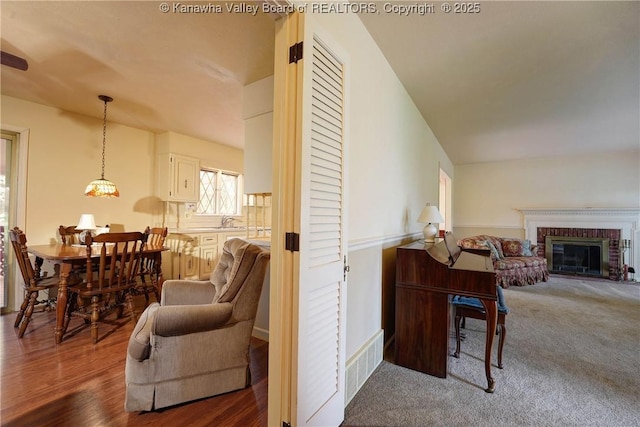 906 Hughes Dr, Saint Albans, WV 25177 - living room featuring dark wood-style flooring, visible vents, and a fireplace