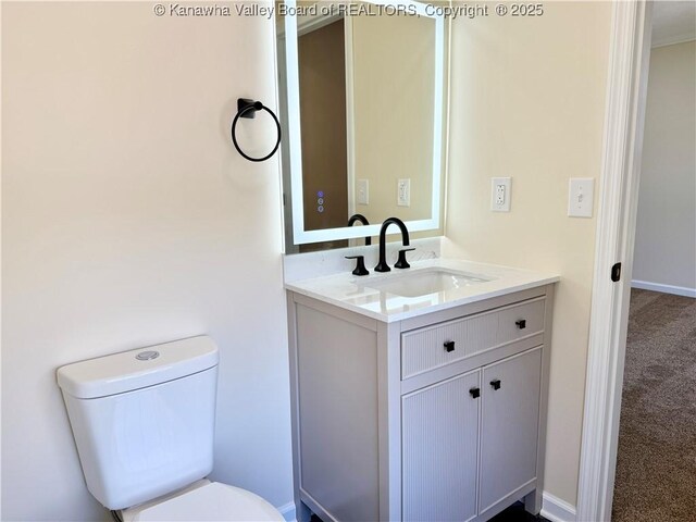 219 Westmoreland Dr, Dunbar, WV 25064 - half bathroom featuring toilet, vanity, and baseboards