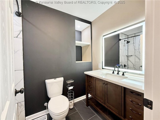 full bath with vanity, toilet, walk in shower, tile patterned floors, and baseboards