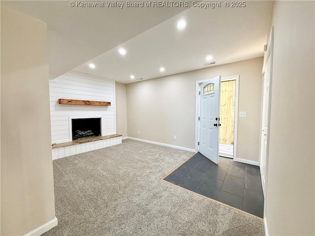 unfurnished living room featuring carpet flooring, baseboards, visible vents, and recessed lighting