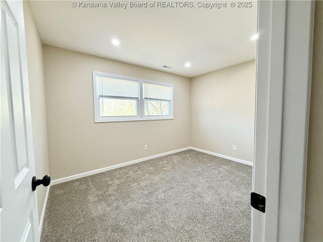 carpeted empty room featuring baseboards, visible vents, and recessed lighting