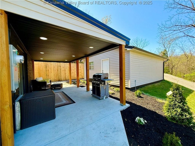 view of patio with a grill and fence