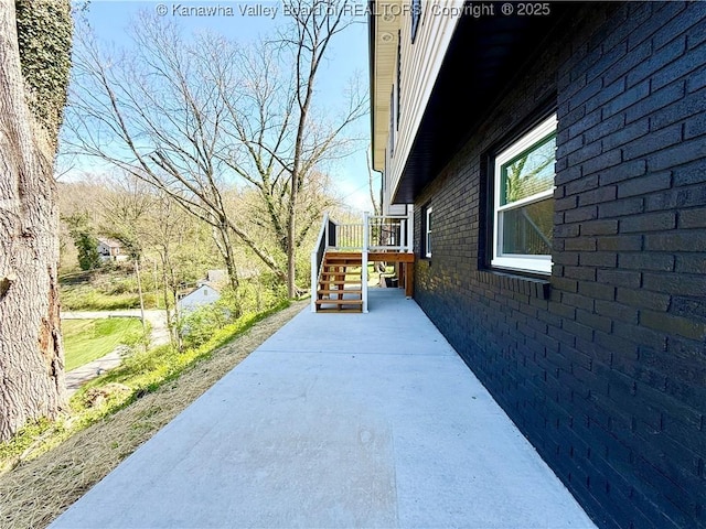 view of property exterior with brick siding