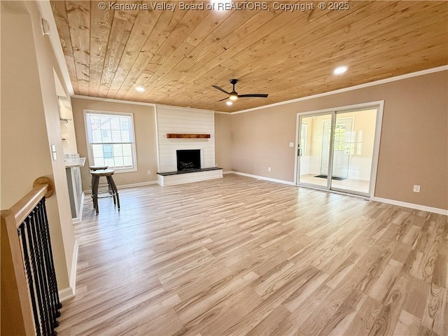 unfurnished living room with light wood-style flooring, a ceiling fan, wooden ceiling, and crown molding