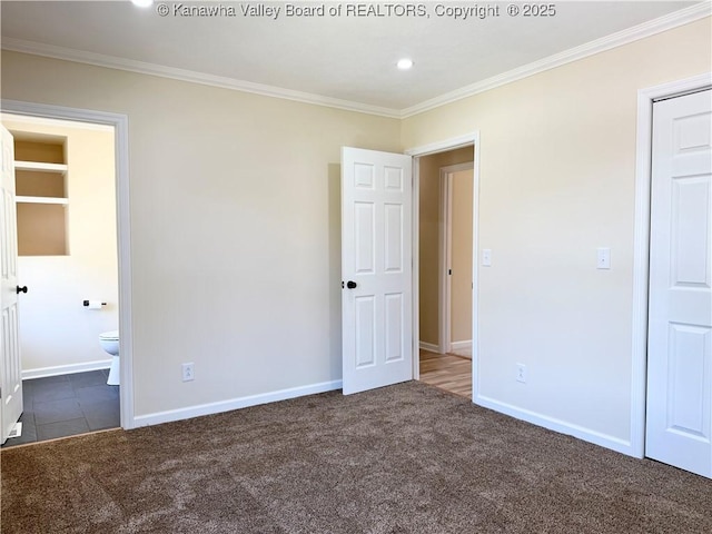 unfurnished bedroom featuring crown molding, carpet floors, and baseboards