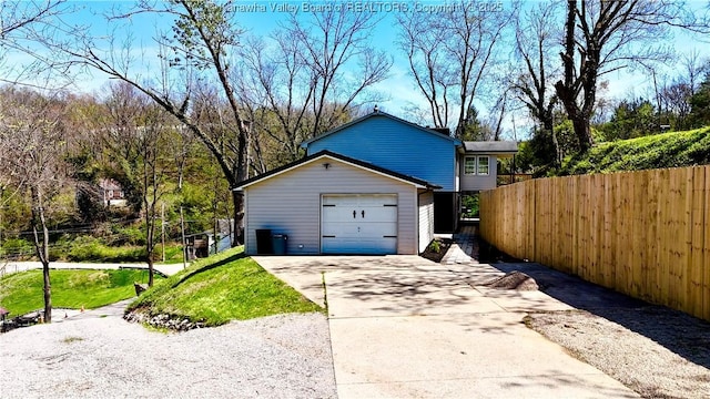exterior space featuring driveway and fence