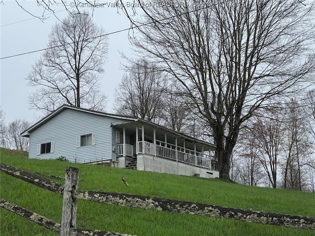 view of front of home with a front yard and covered porch