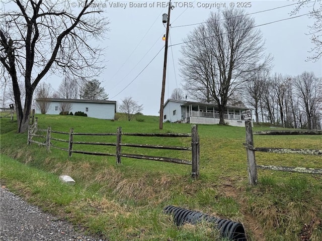 exterior space with a rural view and fence
