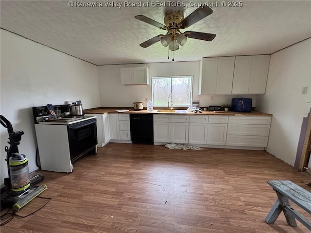 kitchen featuring a sink, wooden counters, ceiling fan, black appliances, and wood finished floors