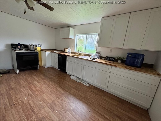 kitchen with white cabinets, electric range oven, black dishwasher, light wood-style floors, and butcher block countertops