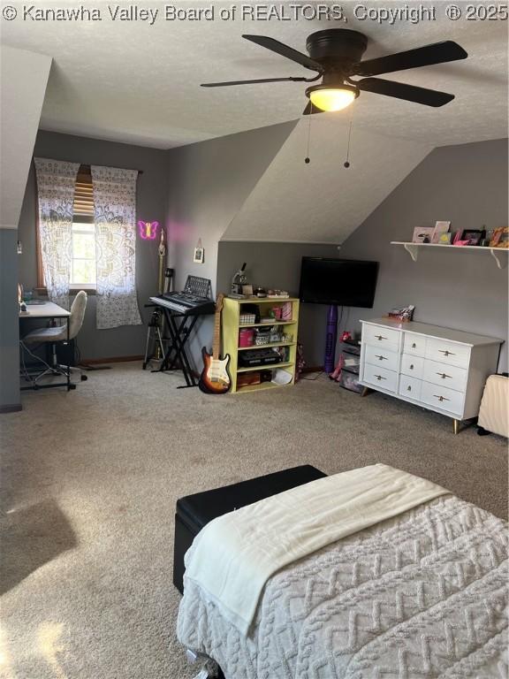 bedroom with carpet flooring, a textured ceiling, ceiling fan, and vaulted ceiling
