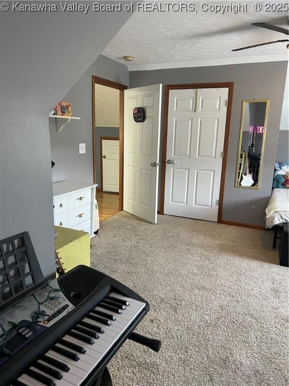 interior space with a ceiling fan and a textured ceiling