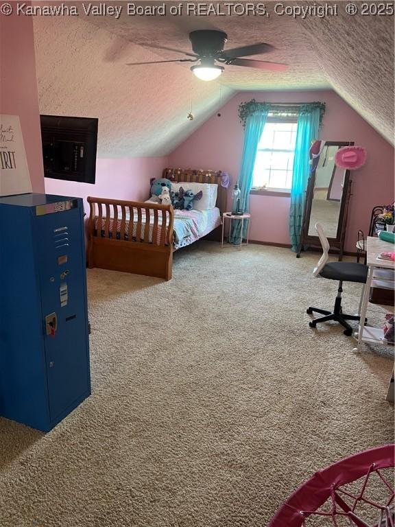 bedroom featuring carpet floors, a textured ceiling, ceiling fan, and lofted ceiling