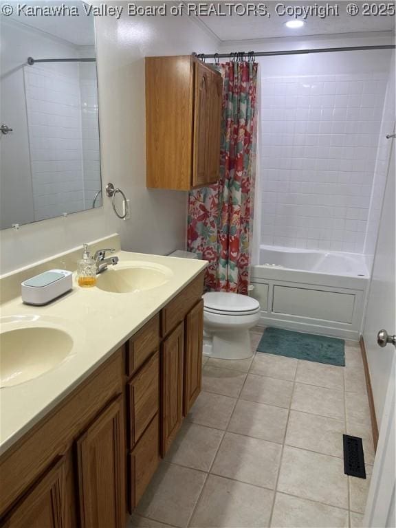 full bathroom with toilet, tile patterned floors, shower / bath combination with curtain, and a sink