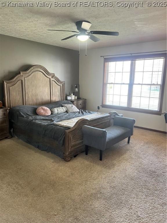 bedroom with light colored carpet, a textured ceiling, and ceiling fan