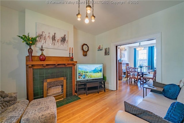12 Arlington Ct, Charleston, WV 25301 - living room featuring wood finished floors, a fireplace, and baseboards