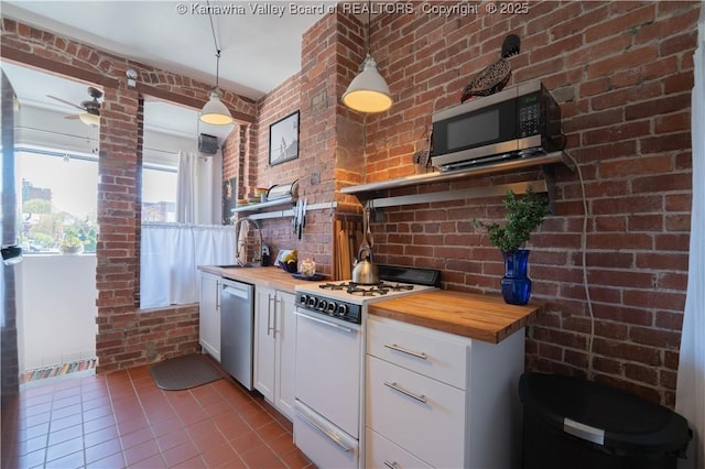 12 Arlington Ct, Charleston, WV 25301 - kitchen with a sink, wooden counters, appliances with stainless steel finishes, ceiling fan, and tile patterned flooring