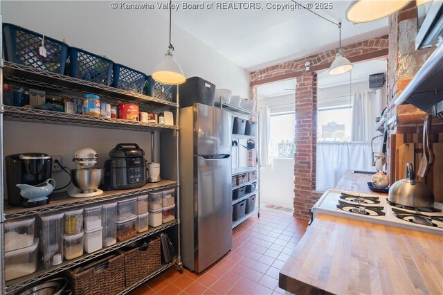 12 Arlington Ct, Charleston, WV 25301 - kitchen featuring tile patterned floors, decorative light fixtures, freestanding refrigerator, and stovetop