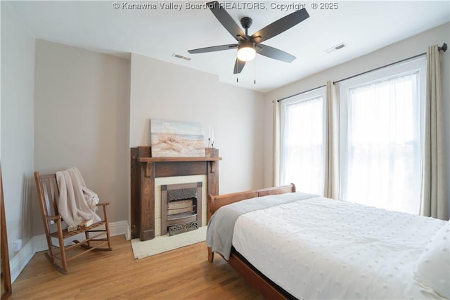 12 Arlington Ct, Charleston, WV 25301 - bedroom with a fireplace with flush hearth, light wood-type flooring, baseboards, and visible vents