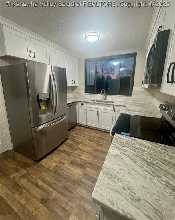5218 Walnut Valley Dr, Charleston, WV 25313 - kitchen featuring stainless steel appliances, a sink, white cabinets, backsplash, and dark wood finished floors