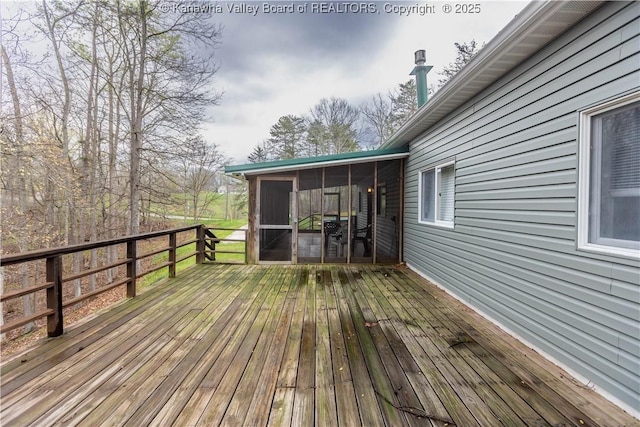 wooden deck with a sunroom