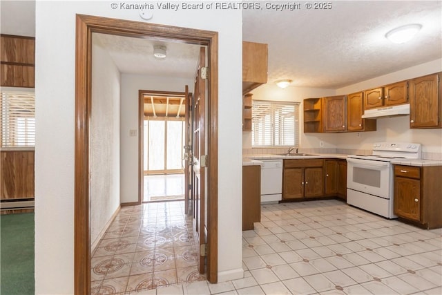 kitchen with white appliances, open shelves, under cabinet range hood, light countertops, and a sink