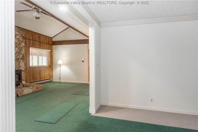 carpeted spare room featuring baseboards, a baseboard heating unit, vaulted ceiling, a ceiling fan, and a wood stove
