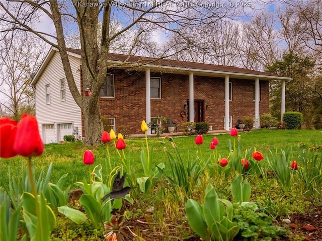 139 Betty Ln, Scott Depot, WV 25560 - exterior space featuring a lawn, brick siding, and an attached garage