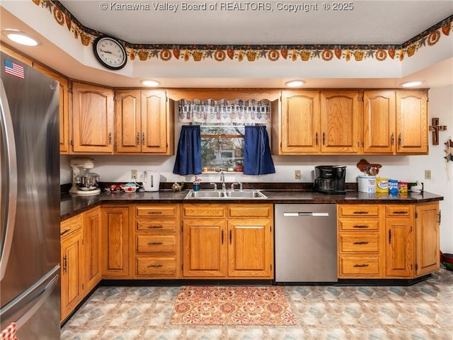 139 Betty Ln, Scott Depot, WV 25560 - kitchen featuring dark countertops, brown cabinets, a sink, and stainless steel appliances