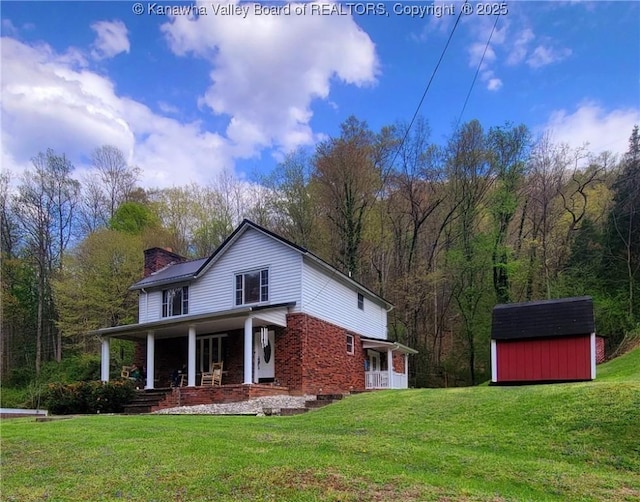 95 Grey Squirrel Ln, Gallagher, WV 25083 - rear view of house with a shed, a yard, a porch, a chimney, and an outbuilding