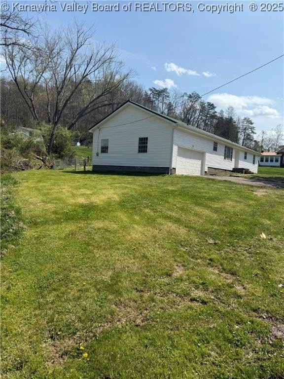 1651 Glenwood Rd, Milton, WV 25541 - view of property exterior featuring fence, a garage, and a lawn