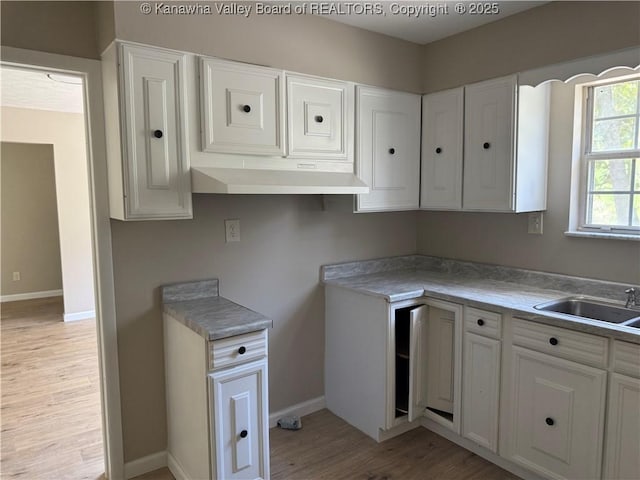 1651 Glenwood Rd, Milton, WV 25541 - kitchen with a sink, baseboards, light wood-type flooring, and white cabinets