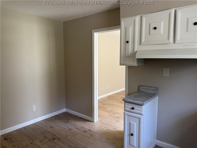 1651 Glenwood Rd, Milton, WV 25541 - kitchen with white cabinetry, wood finished floors, and baseboards