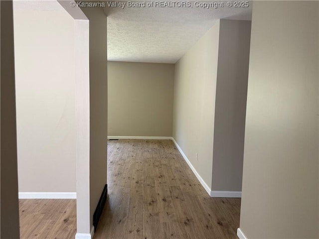 1651 Glenwood Rd, Milton, WV 25541 - hall featuring baseboards, a textured ceiling, and wood finished floors
