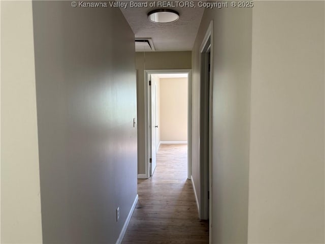 1651 Glenwood Rd, Milton, WV 25541 - hall featuring a textured ceiling, attic access, baseboards, and wood finished floors