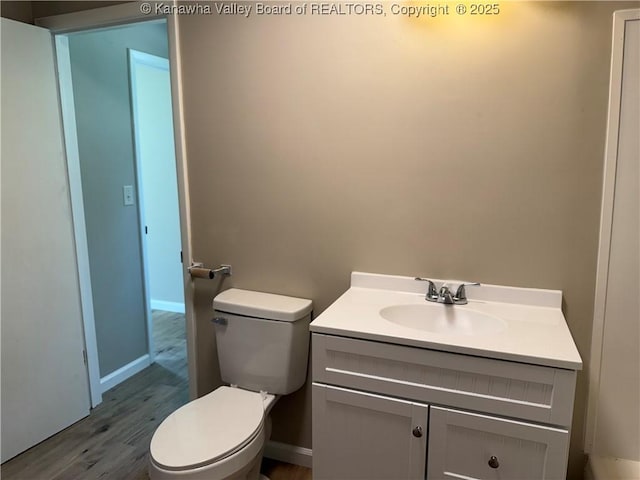 1651 Glenwood Rd, Milton, WV 25541 - half bathroom featuring toilet, baseboards, wood finished floors, and vanity