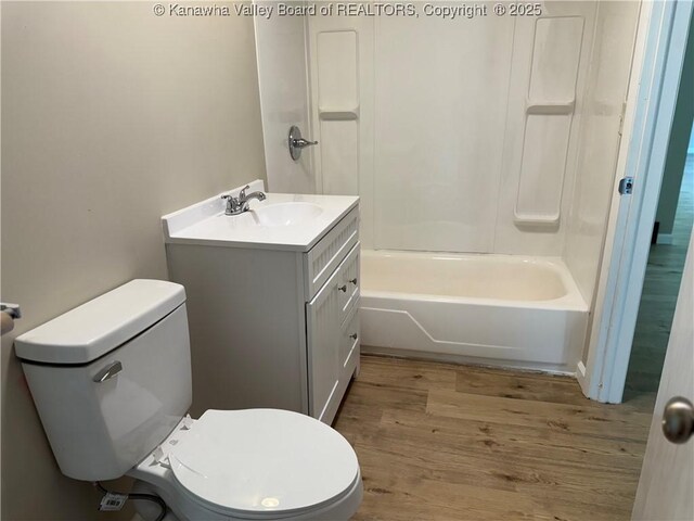 1651 Glenwood Rd, Milton, WV 25541 - bathroom with toilet, wood finished floors, vanity, and shower / tub combination